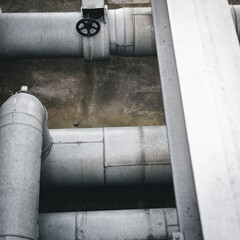 Wall Mural - Overhead of huge white pipes of water with black valve