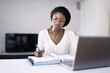 © Andrey Popov - Happy Young African Woman Doing Taxes