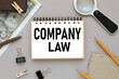 Corporate Law, COMPANY Law, text on notepad near magnifier and card with notepad