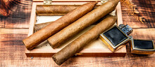 Cigars In Box And Vintage Lighter. Cuban Cigars Wooden Background. Cigar Smoking. Cigar Tobacco