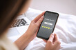 © New Africa - Woman using smartphone to give feedback indoors, closeup. Customer review