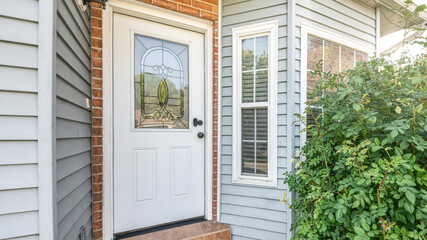 Wall Mural - Pano Front door exterior with bricks and vinyl siding wall