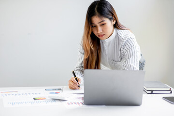 Business achievement concept with happy young business woman working on laptop in office or home, do math report finance tax, accounting, statistics and analytical research.