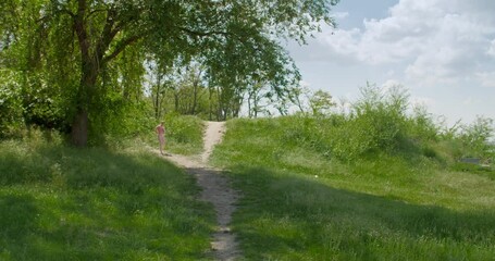 Canvas Print - Sporty young woman running in park