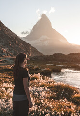 Fototapete - Woman enjoying the view at the famous Matterhorn from the Riffelsee.