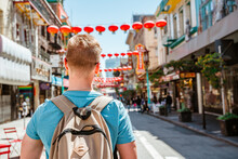 Rear view of a young man walking through Chinatown in downtown San Francisco. San Francisco, USA - 18 Apr 2021