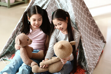 Poster - Cute Asian sisters playing with toys at home