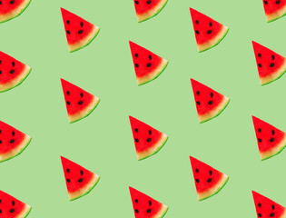 Wall Mural - Creative composition made with watermelon slices on pastel green background. Summer fruit pattern.