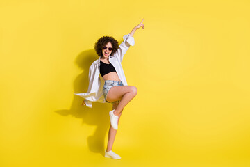 Poster - Full size photo of young lovely pretty sweet smiling cheerful girl with curly hair dancing isolated on yellow color background