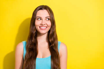 Sticker - Portrait of attractive cheerful girl looking aside guessing copy space ad isolated over bright yellow color background