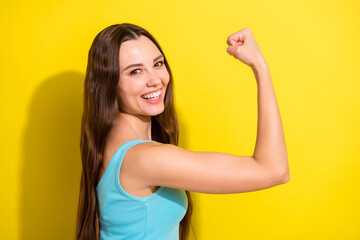 Sticker - Photo of funny brunette hairdo young sporty lady show muscle wear teal top isolated on vivid yellow color background