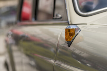 Sticker - Closeup of a yellow turn signal light on a white retro car