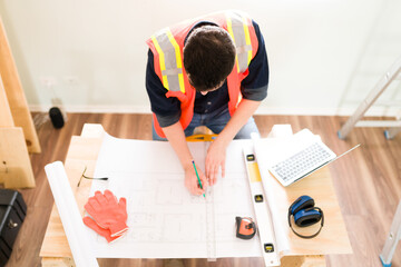 Wall Mural - High angle of a contractor working at his desk