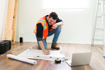 Wall Mural - Happy contractor checking the blueprints