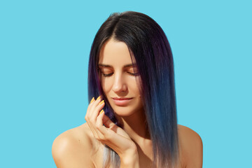 Wall Mural - Face of young beautiful woman with blue hair on bright background