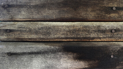 Wall Mural - Old gray brown wooden background made of natural horizontal boards with nails in grunge style. Top view. Raw planed texture of coniferous pine. Surface of table to shoot flat lay. Copy space.