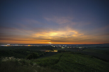 Wall Mural - beautiful sunrise over a field and a small town in summer in ukraine