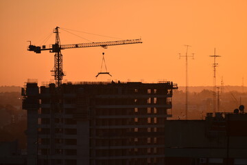 construction of a high-rise with a crane in evening light, Buenos Aires