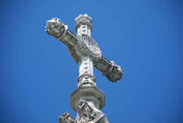 Canvas Print - Low angle shot of a church cross on blue sky background in Vienna