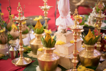 Wall Mural - Traditional Indian brass oil lamps and flowers during a wedding ceremony