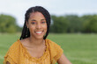 © J - smiling African American woman close up outdoors at a park