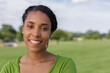 © J - African-American woman smiling outdoors in park close up - 235