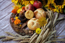 Wiccan Altar For Lammas, Lughnasadh Pagan Holiday. Wheel Of The Year With Ears Of Wheat, Homemade Bread, Flowers, Apple, Candle On Dark Background. Symbol Of Celtic Wiccan Sabbath, Summer Season