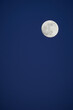 Close-up of a full moon in the deep blue sky