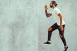 © Manpeppe - Crazy young man jumping in casual white t-shirt posing isolated on grey wall background. People lifestyle concept. Copy space.