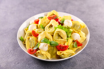 tortellini with mozzarella,  tomato and basil