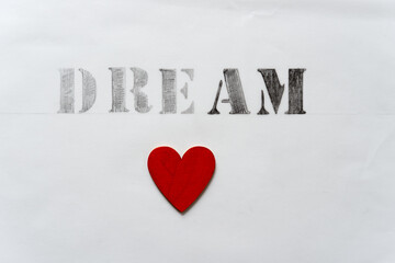 Sticker - the word dream rendered in classic stencil font on tracing paper - includes a hand painted red heart