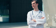 © yurolaitsalbert - tired young doctor standing near the entrance to the hospital .