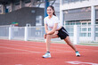 © EduLife Photos - A young beautiful Asian woman in sports outfits doing stretching before workout outdoor in the park in the morning to get a healthy lifestyle. Healthy young woman warming up outdoors