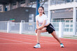 © EduLife Photos - A young beautiful Asian woman in sports outfits doing stretching before workout outdoor in the park in the morning to get a healthy lifestyle. Healthy young woman warming up outdoors