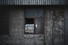 broken glass of window of abandoned ruin of old soviet plant
