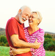 © Lumos sp - woman man outdoor senior couple happy lifestyle retirement together smiling love hug nature mature