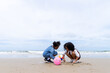 © godji10 - Joyful African American kid enjoying with sand together at beach