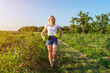 © Serhii - Young female farmer picking blueberries and carrying baskets with berries in hands on organic farm. Family business concept.