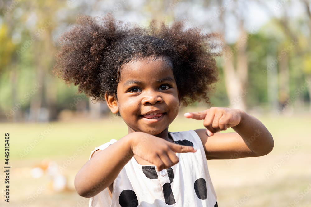 Cheerful African American toddler little girl playing outdoor in the park. Cute black people child girl with hair curly laughing outdoor Stock Photo Adobe Stock