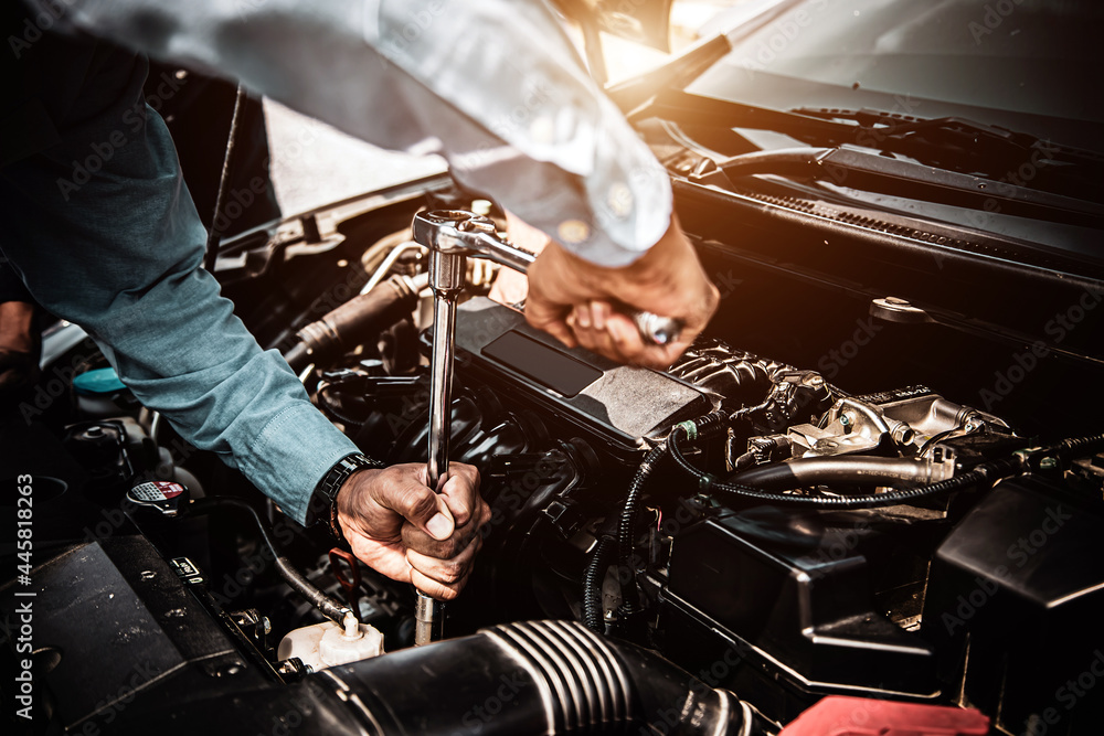 Car care maintenance and servicing, Close-up hand technician auto mechanic using the wrench to repairing change spare part car engine problem. Concepts of check and during periodic inspection service. - obrazy, fototapety, plakaty 