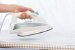 © Владислав Легір - Steam blue iron on ironing board. Clothes, ironing board household concept