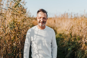 attractive casual middle-aged man enjoying a day at the coast