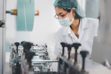 Asian Female Doctor Or Engineer Working At Clean Medical Mask Production Factory