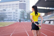 © EduLife Photos - A young beautiful Asian woman in sports outfits doing stretching before workout outdoor in the city stadium  in the morning to get a healthy lifestyle. Healthy young woman doing excercise