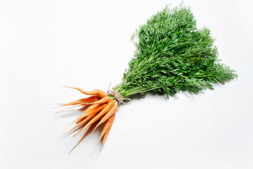 Close-up of bunch of carrots tied with a rope on white background. Top view.