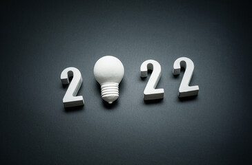 Canvas Print - 2022 Creativity and inspiration ideas concepts with lightbulb on dark color background.