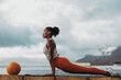 © Jacob Lund - Sportswoman doing cobra pose yoga on rooftop