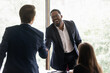 © fizkes - Happy diverse business leader and client shaking hands on meeting. Confident lawyer, bank employee, broker giving handshake to investor, partner. Employer hiring job candidate after interview