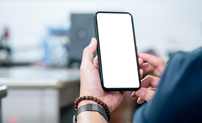 Wall Mural - cropped shot of man hand holding blank screen smartphone with blurred background.