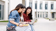 © DMegias - three asian girl students using the laptop at break time sitting on campus